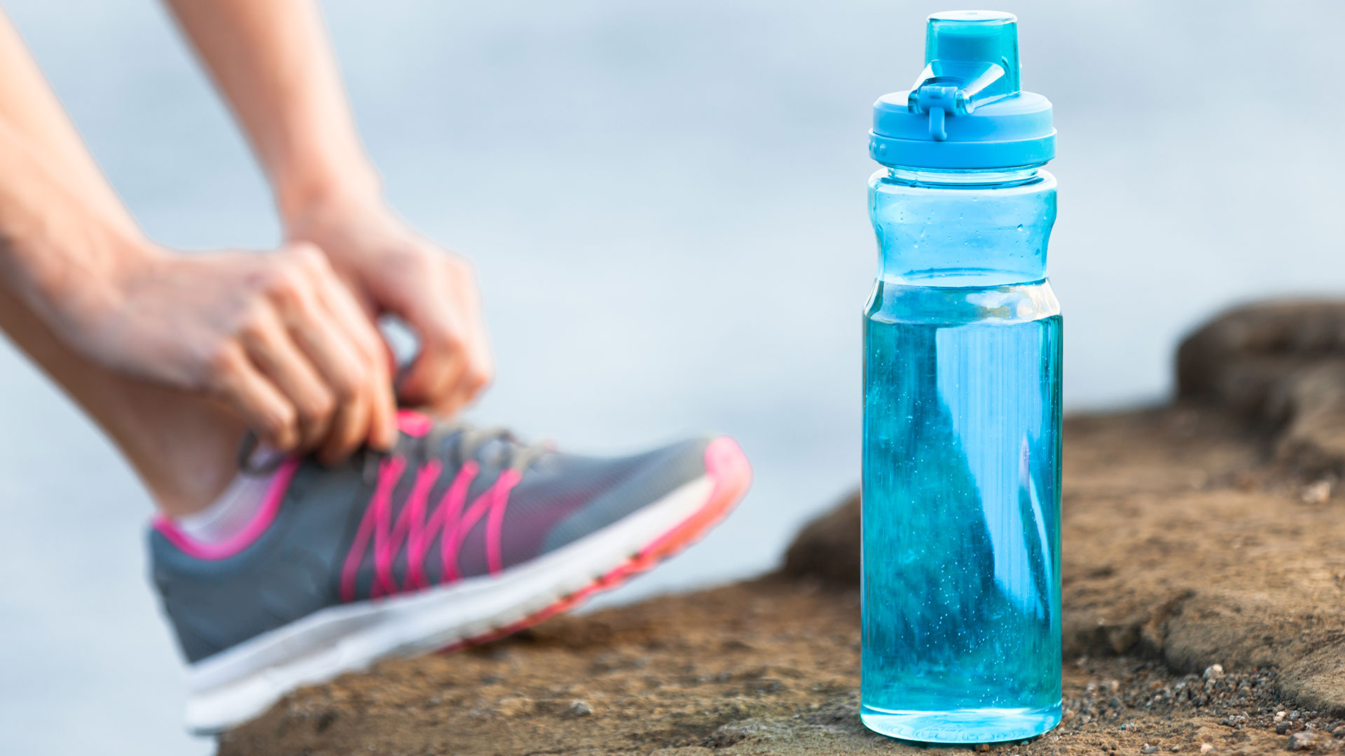 woman preparing to exercise with water bottle